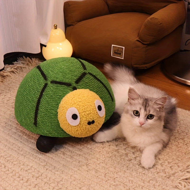 Kitten playing with a green and yellow plush toy resembling a brussels sprout on a carpeted floor.