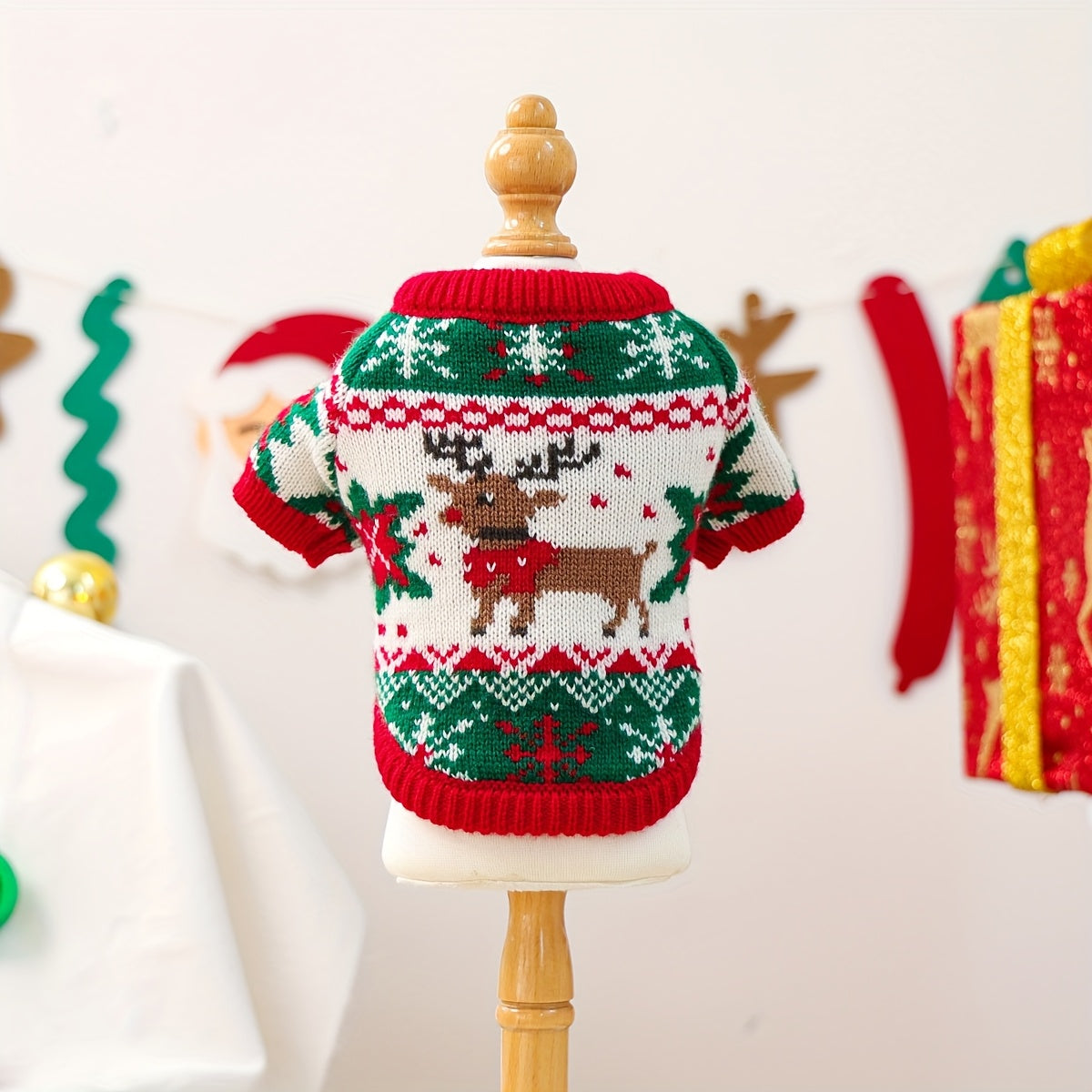 Christmas-themed dog sweater on a mannequin with a festive background