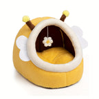 Yellow pet bed shaped like a bee with antennae and a flower on a white background