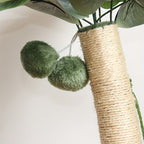 Close-up of a cat tree with green spherical cushions and wicker base.