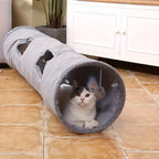Cat inside a gray tunnel on a tiled floor