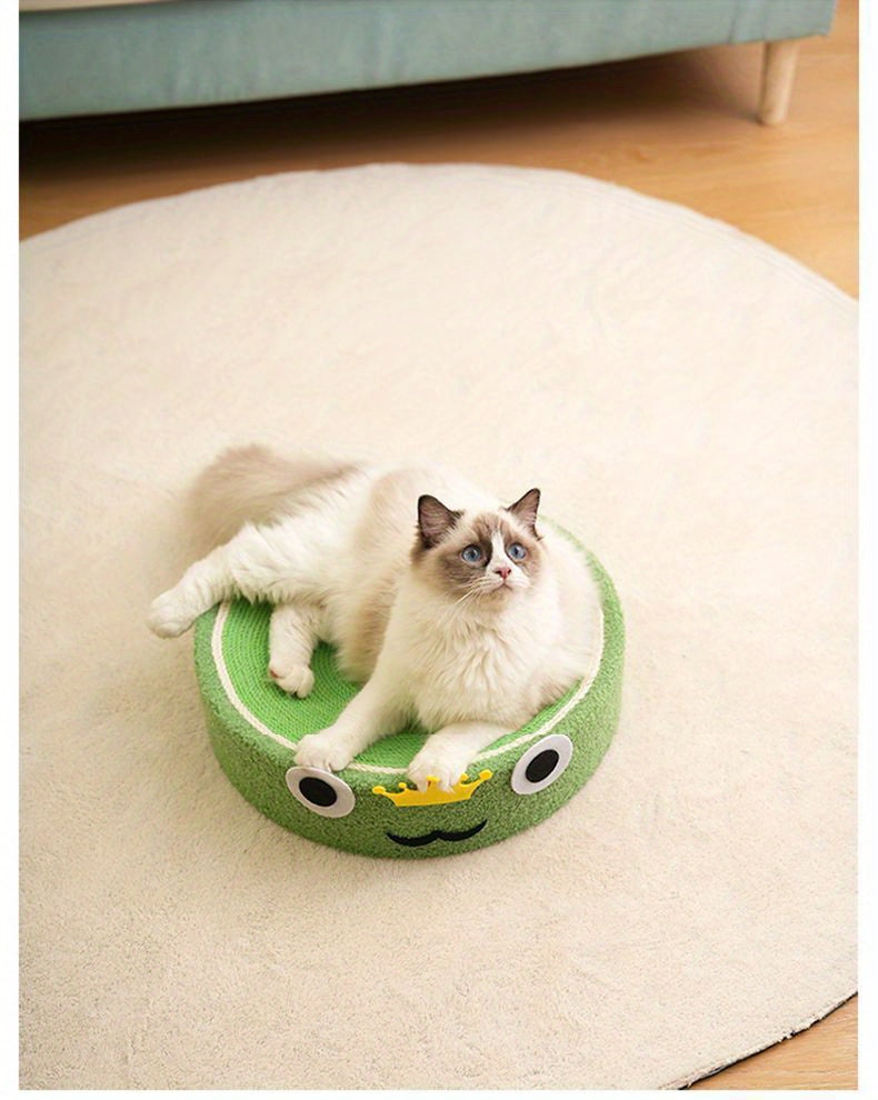 Cat sitting on a green pet bed shaped like a caterpillar on a beige rug.