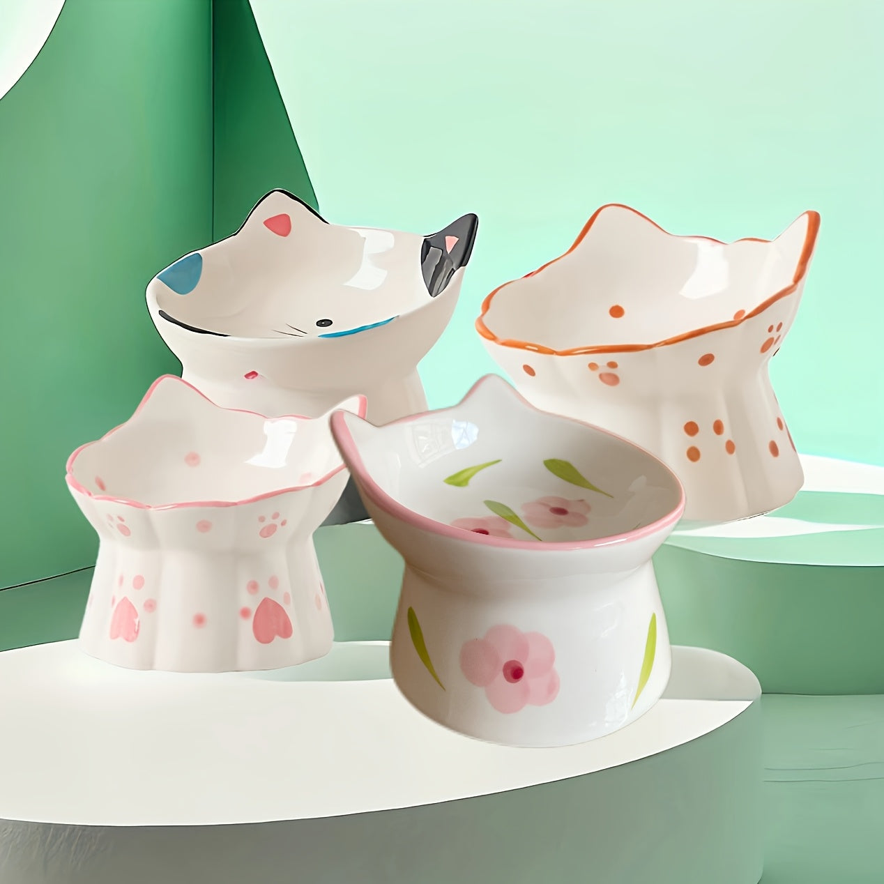 Set of four ceramic bowls with animal designs on a green background