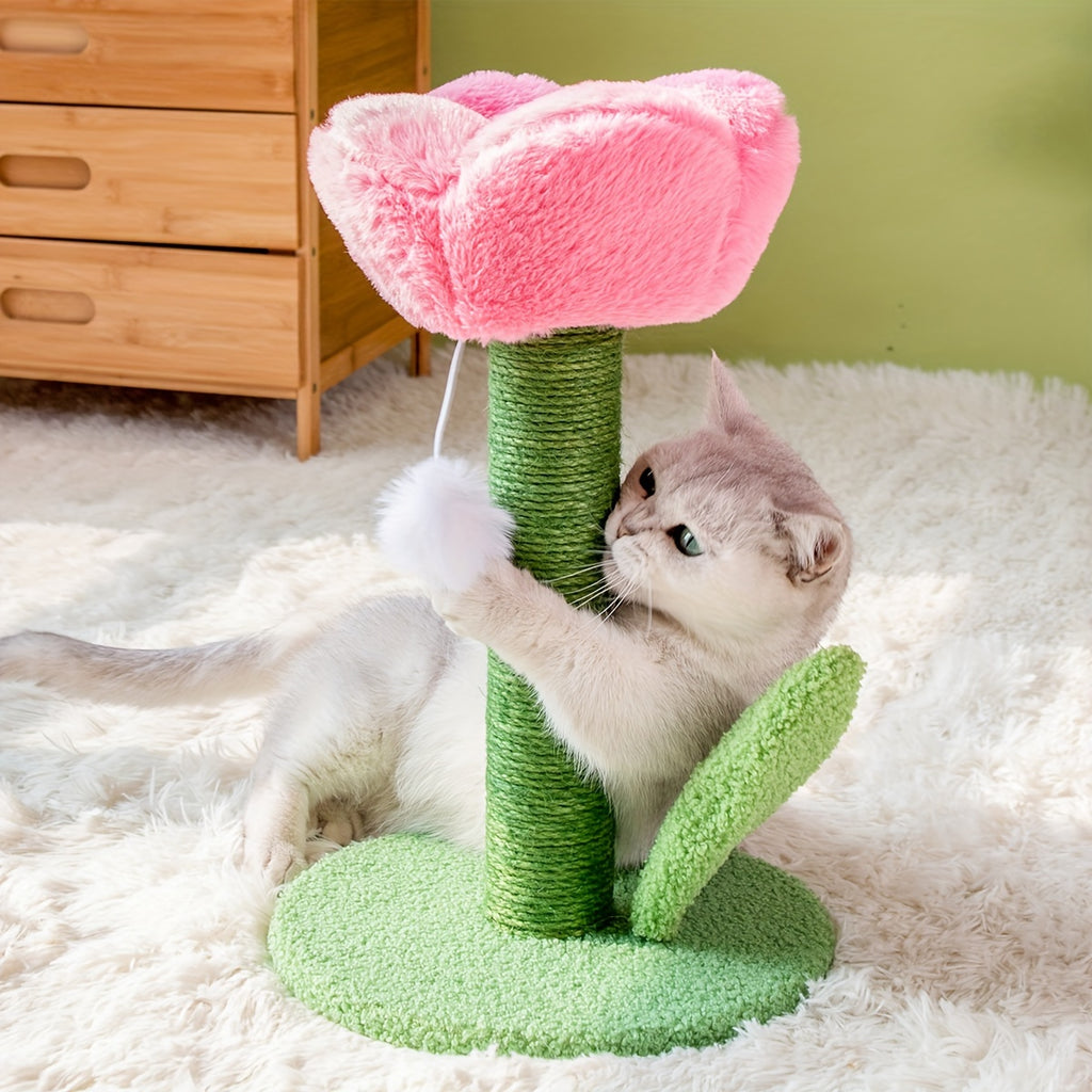Cat playing with a pink and green cat toy shaped like a flower on a fluffy white rug.