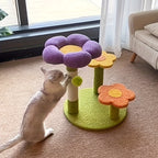 Cat playing with a colorful flower-shaped pet toy on a carpeted floor.