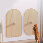 Two wicker cat scratching posts on a white wall with a cat interacting with one of them.