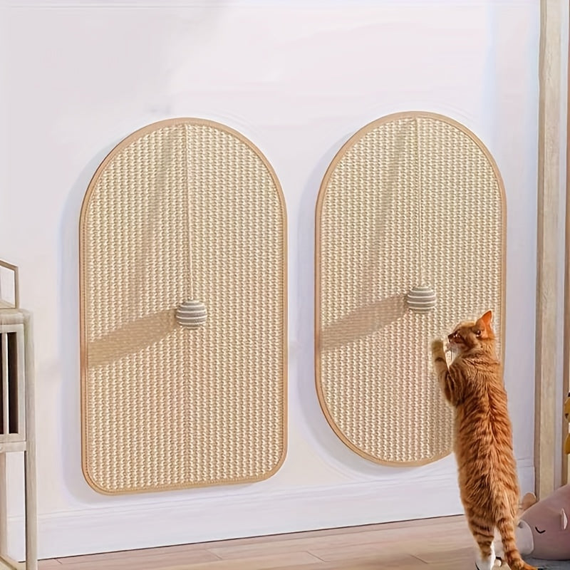 Two wicker cat scratching posts on a white wall with a cat interacting with one of them.