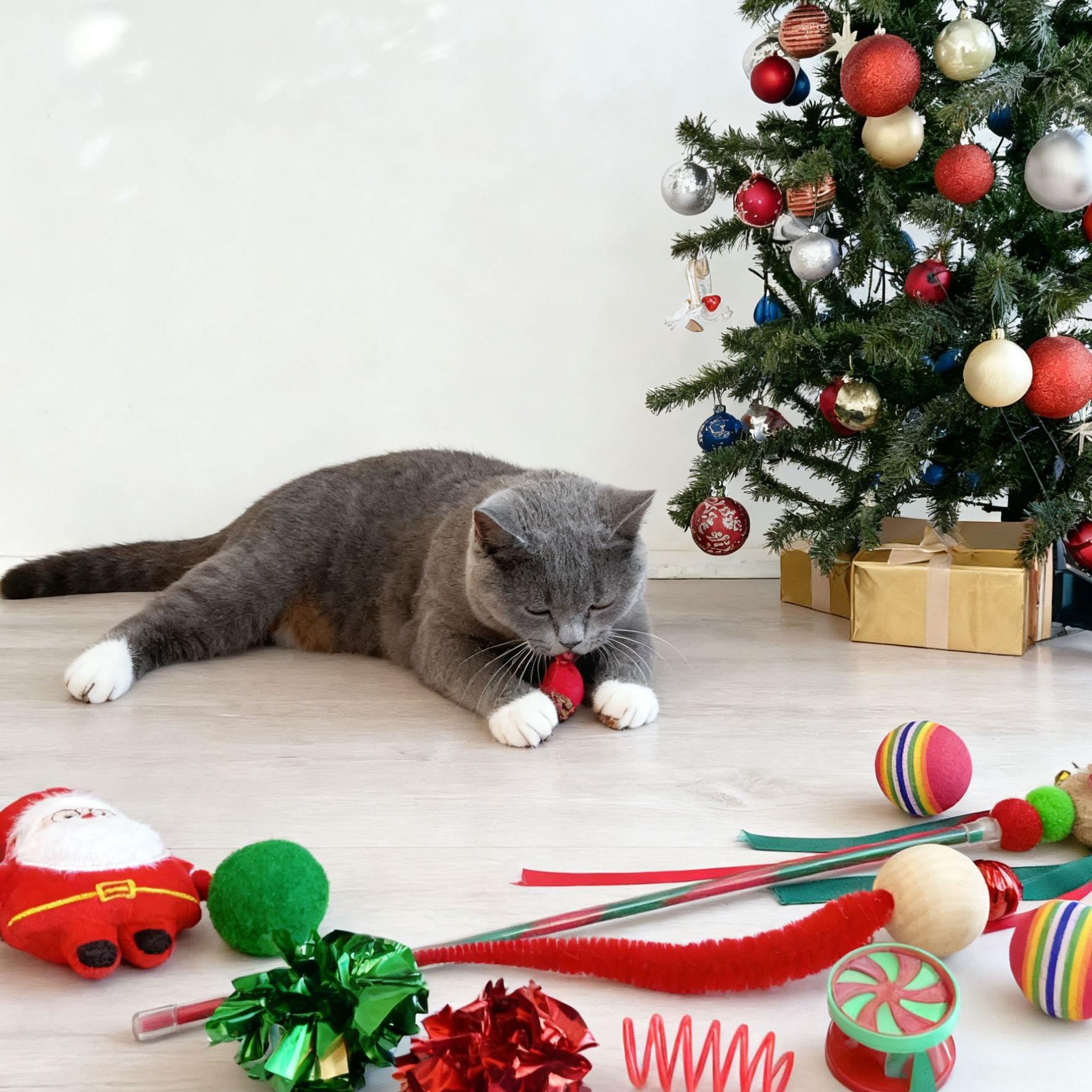 Cat playing with Christmas-themed toys on a floor with a decorated tree in the background