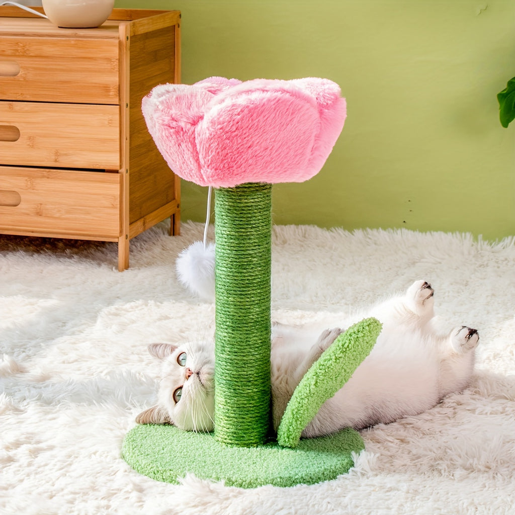 Cat playing with a pink and green cat tree on a fluffy white rug.