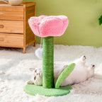 Cat playing with a pink and green cat tree on a fluffy white rug.