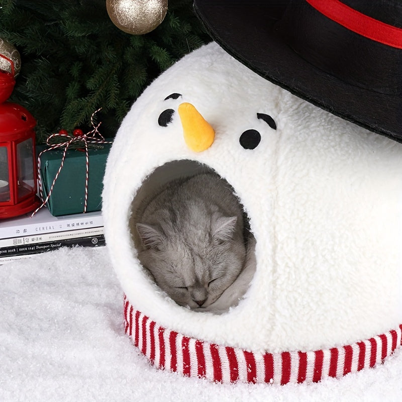 Cat sleeping in a snowman-shaped pet bed with Christmas decorations in the background.
