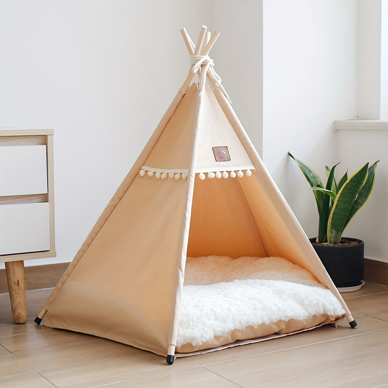 Beige pet teepee with white cushion on a wooden floor, plant in the background